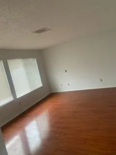a view of room and hall with wooden floor