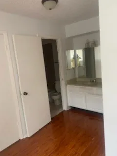 a view of an empty room and wooden floor