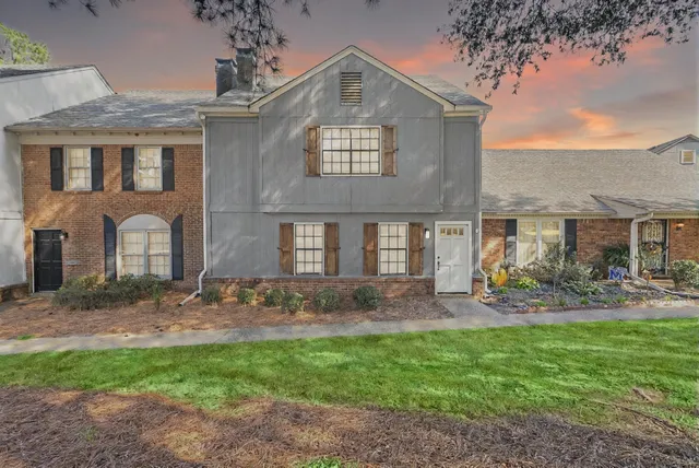 a front view of a house with garden