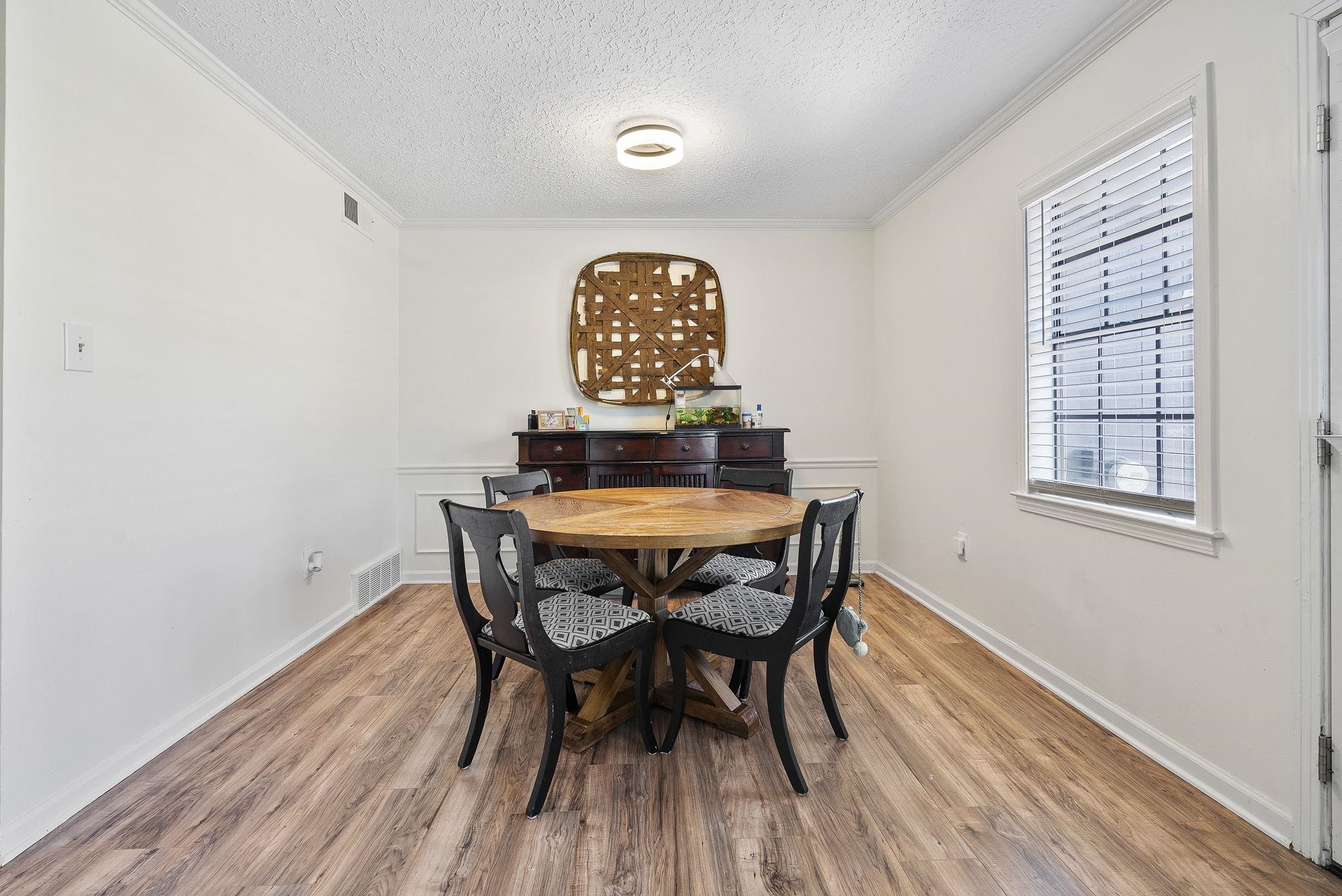 6997 Fords Station Road, Unit 16 Germantown, TN 38138 - Photo 11 of 36 a view of a dining room with furniture and wooden floor
