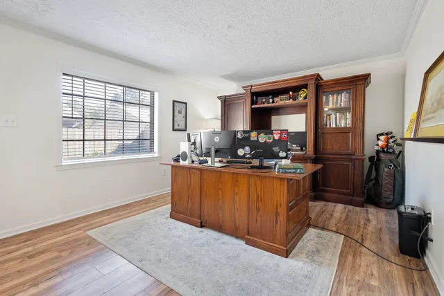 a living room with furniture flat screen tv and windows