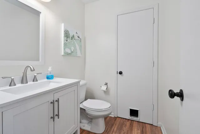 a bathroom with a toilet a sink a vanity and mirror