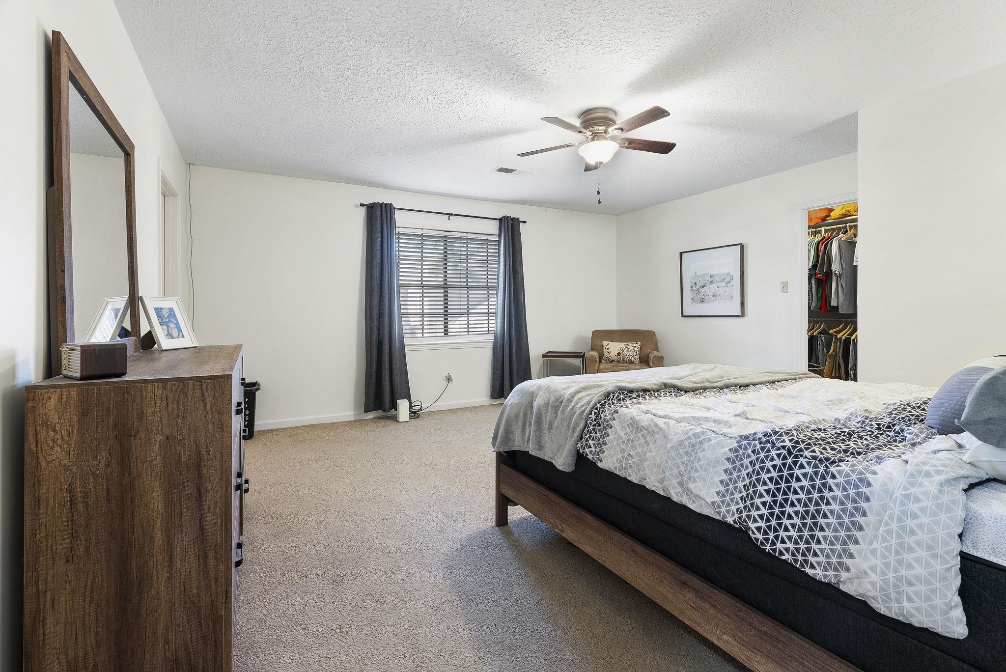 6997 Fords Station Road, Unit 16 Germantown, TN 38138 - Photo 16 of 36 a bedroom with a bed and a chandelier