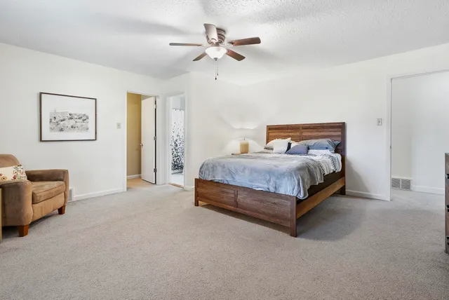 a bedroom with a bed and a chandelier