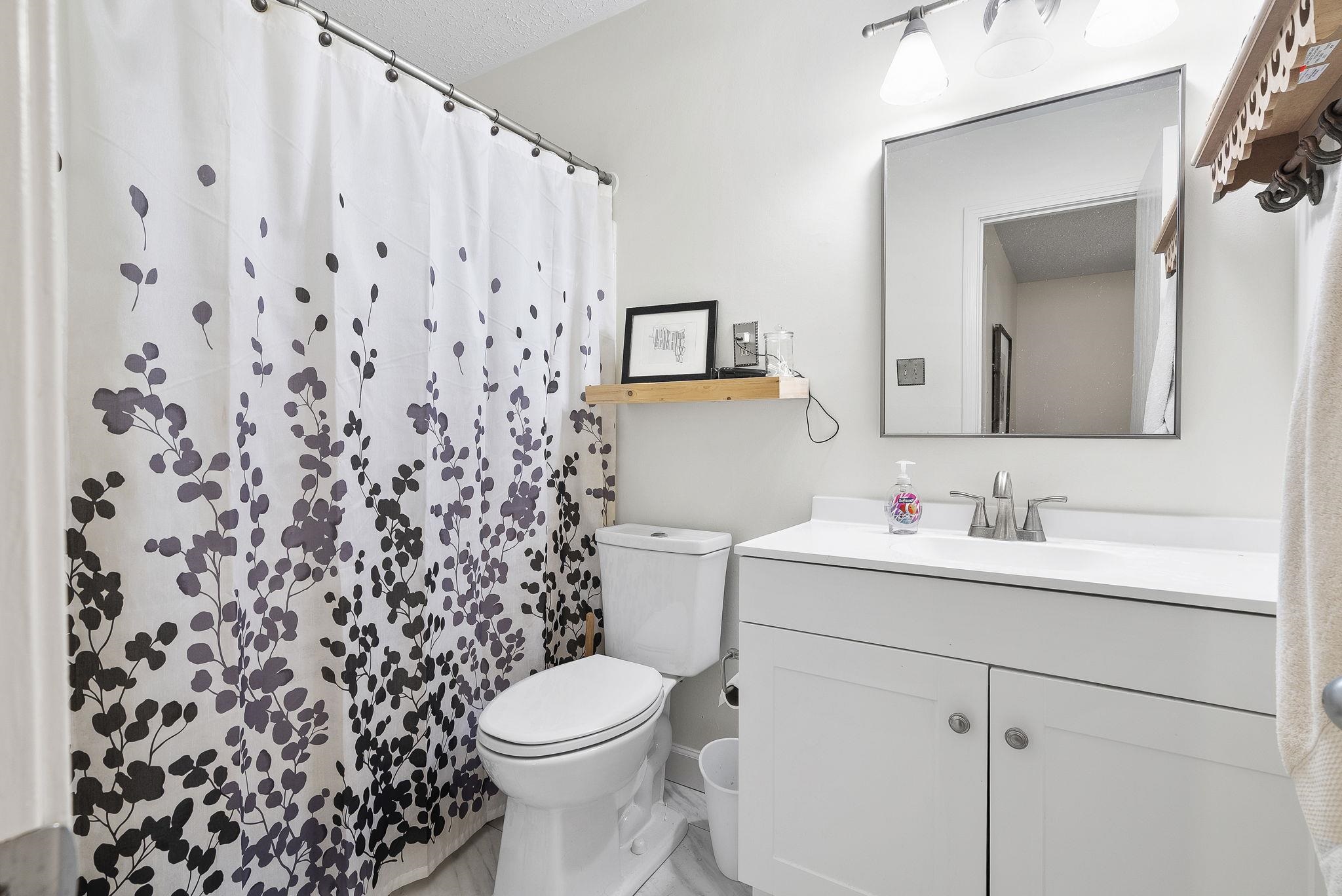 6997 Fords Station Road, Unit 16 Germantown, TN 38138 - Photo 18 of 36 a bathroom with a toilet sink vanity and mirror