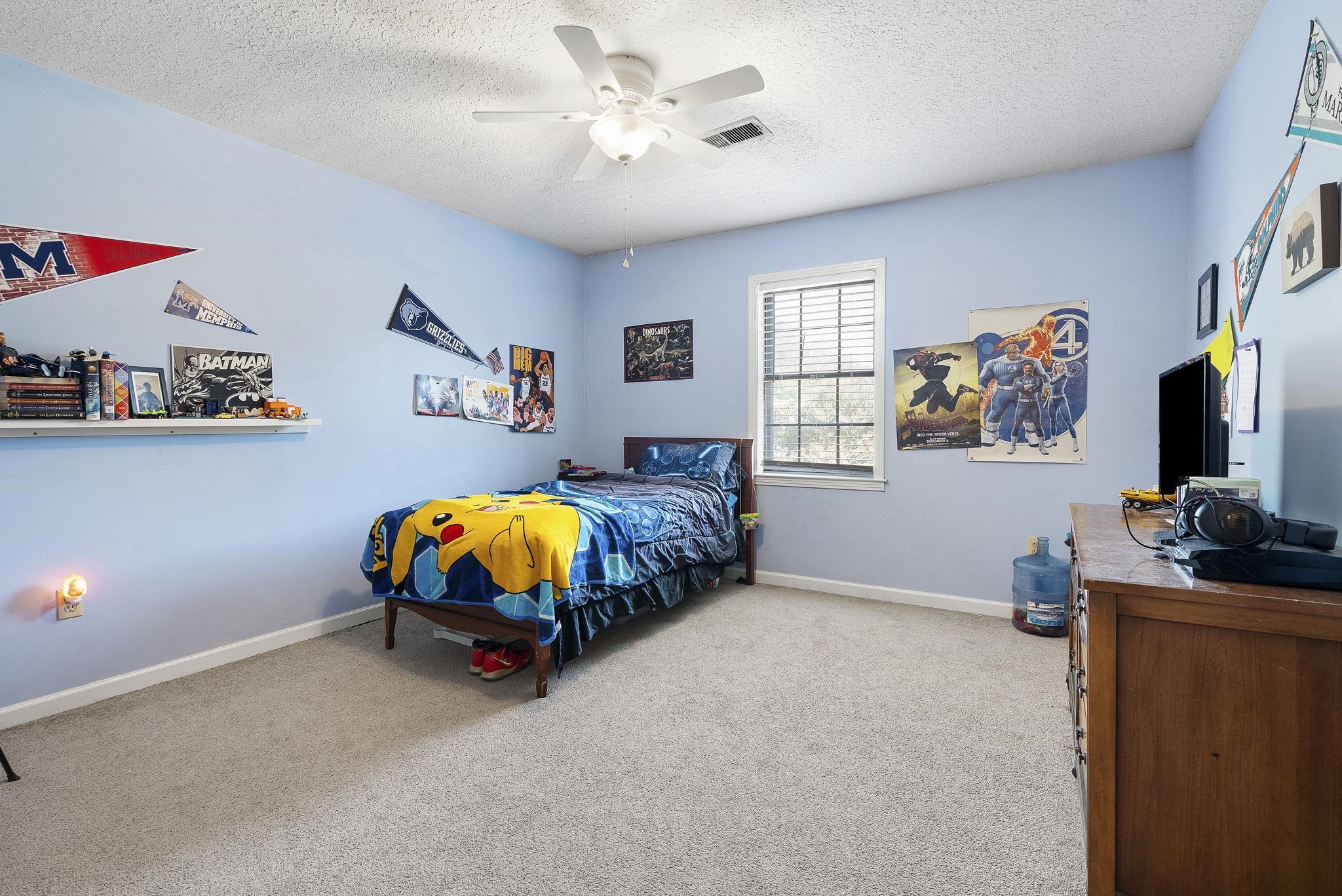 6997 Fords Station Road, Unit 16 Germantown, TN 38138 - Photo 19 of 36 a bedroom with furniture and a flat screen tv