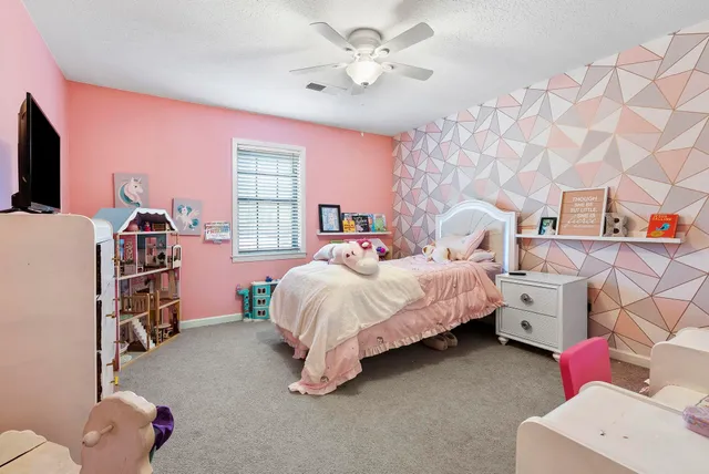 a bed room with a bed and a tv