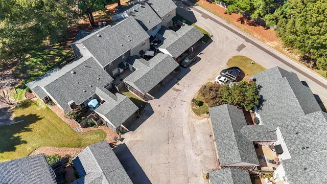an aerial view of a house with a yard and furniture