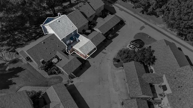 an aerial view of multiple houses with yard