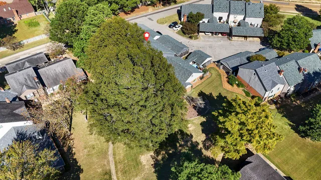 an aerial view of a house with a yard basket ball court and outdoor seating