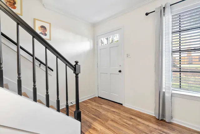 a view of entryway with wooden floor and stairs
