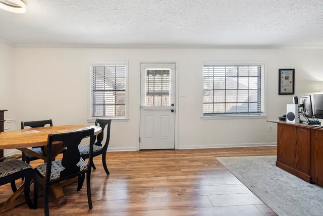 a view of a dining room with furniture and window