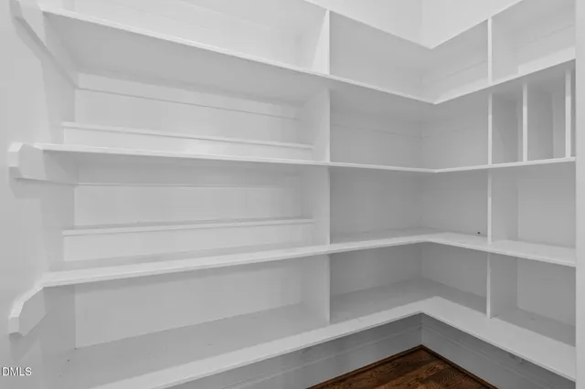 a view of a field with a tree in the background