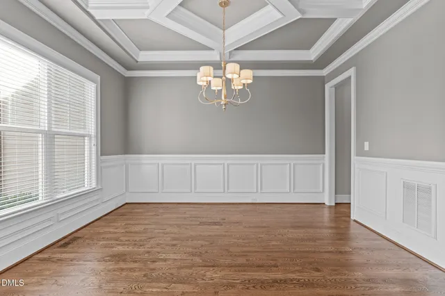 a bathroom with a granite countertop toilet sink and mirror