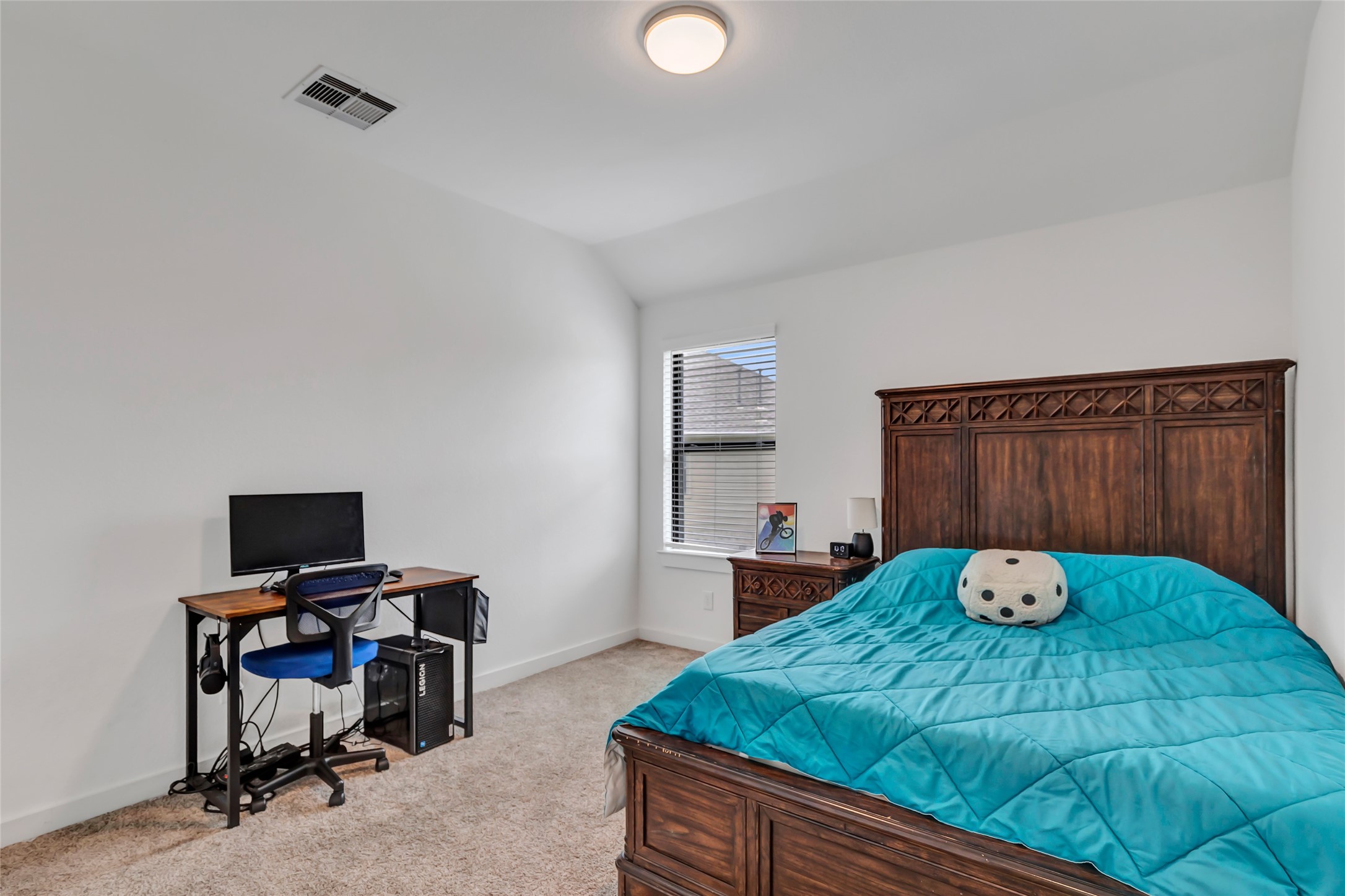 527 Chestnut Reef Court Conroe, TX 77304 - Photo 27 of 40 a bedroom with a bed and a desk
