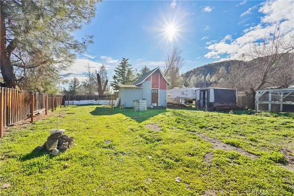 a view of a house with backyard and tree