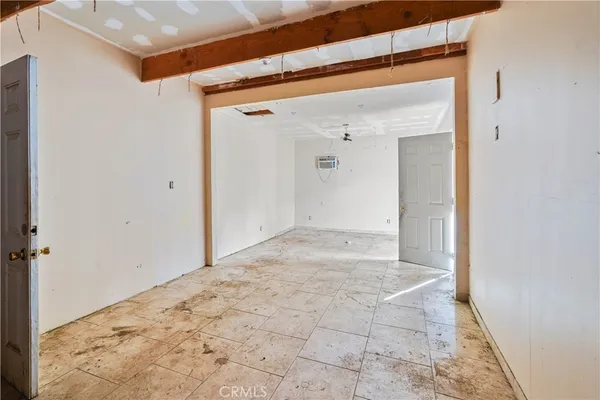 a view of a hallway with wooden floor and a bathroom