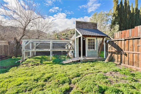 a view of house with backyard and garden