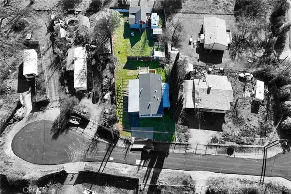 an aerial view of residential houses with outdoor space