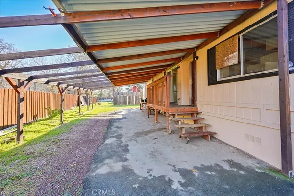 a view of a backyard with a table and chairs