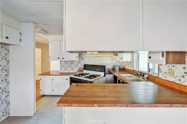 a kitchen with stainless steel appliances granite countertop a sink and a stove