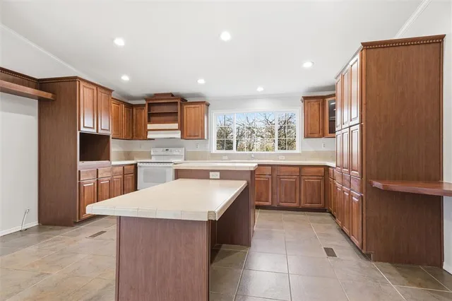 a kitchen with stainless steel appliances granite countertop a sink and cabinets with wooden floor
