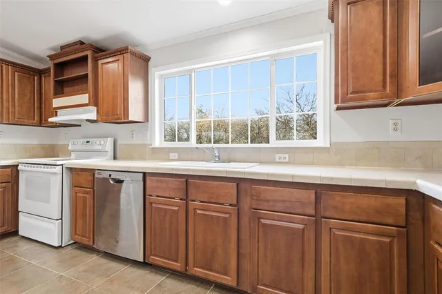 an empty room with wooden floor and a ceiling fan