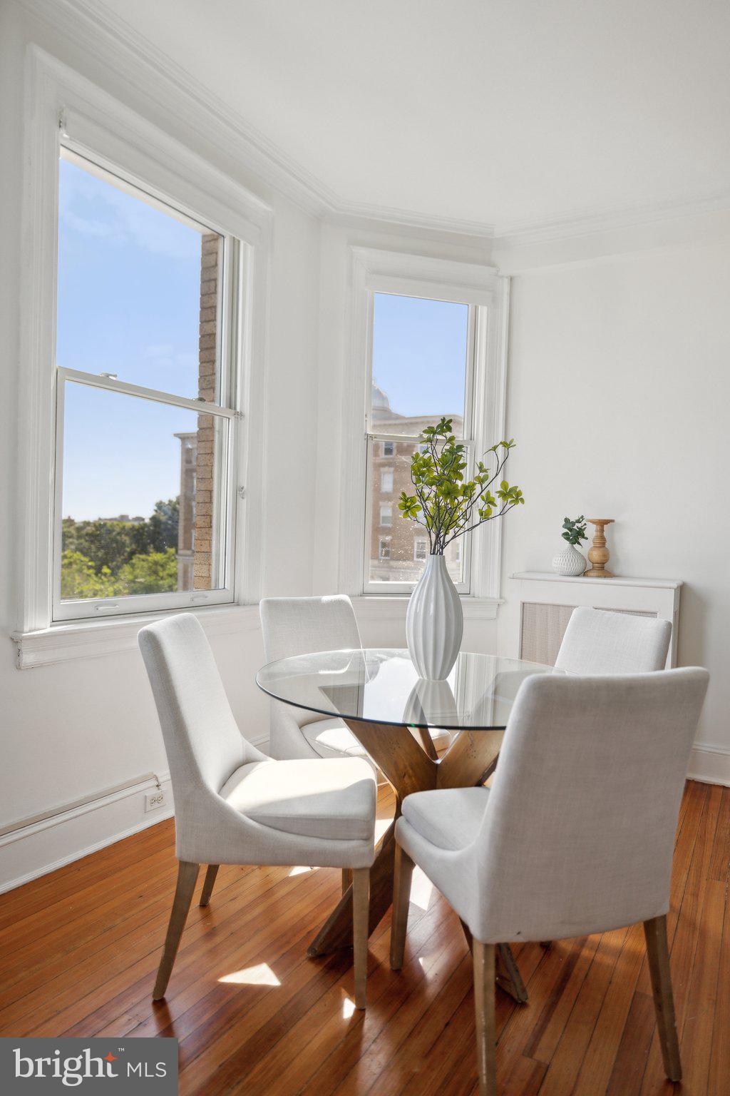 1852 Columbia Road Northwest, Unit 503 Washington, DC 20009 - Photo 11 of 32 a view of a dining room with furniture window and wooden floor