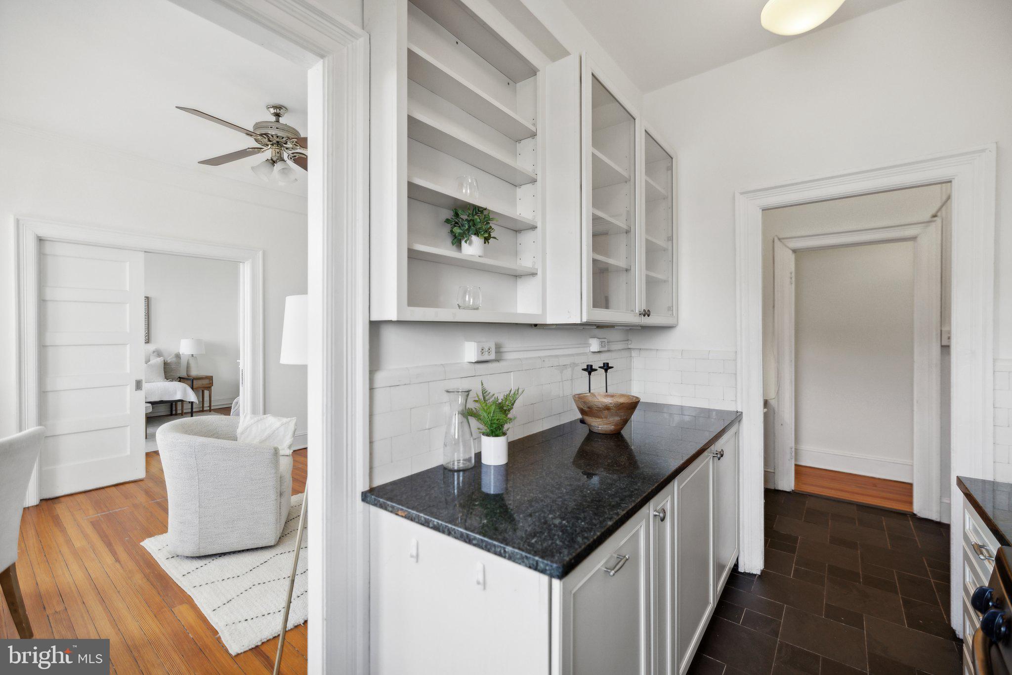 1852 Columbia Road Northwest, Unit 503 Washington, DC 20009 - Photo 15 of 32 a kitchen with stainless steel appliances granite countertop a sink dishwasher and cabinets with wooden floor