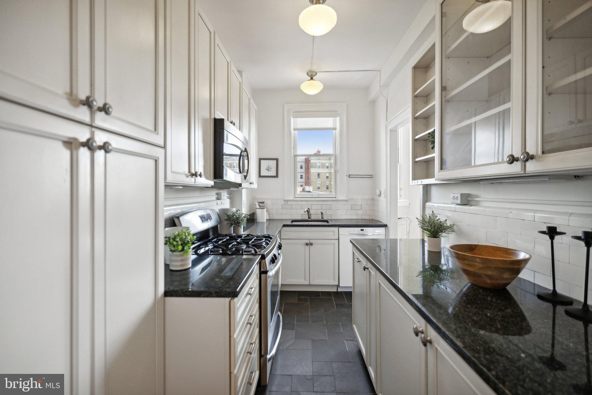 1852 Columbia Road Northwest, Unit 503 Washington, DC 20009 - Photo 18 of 32 a kitchen with a sink appliances and cabinets