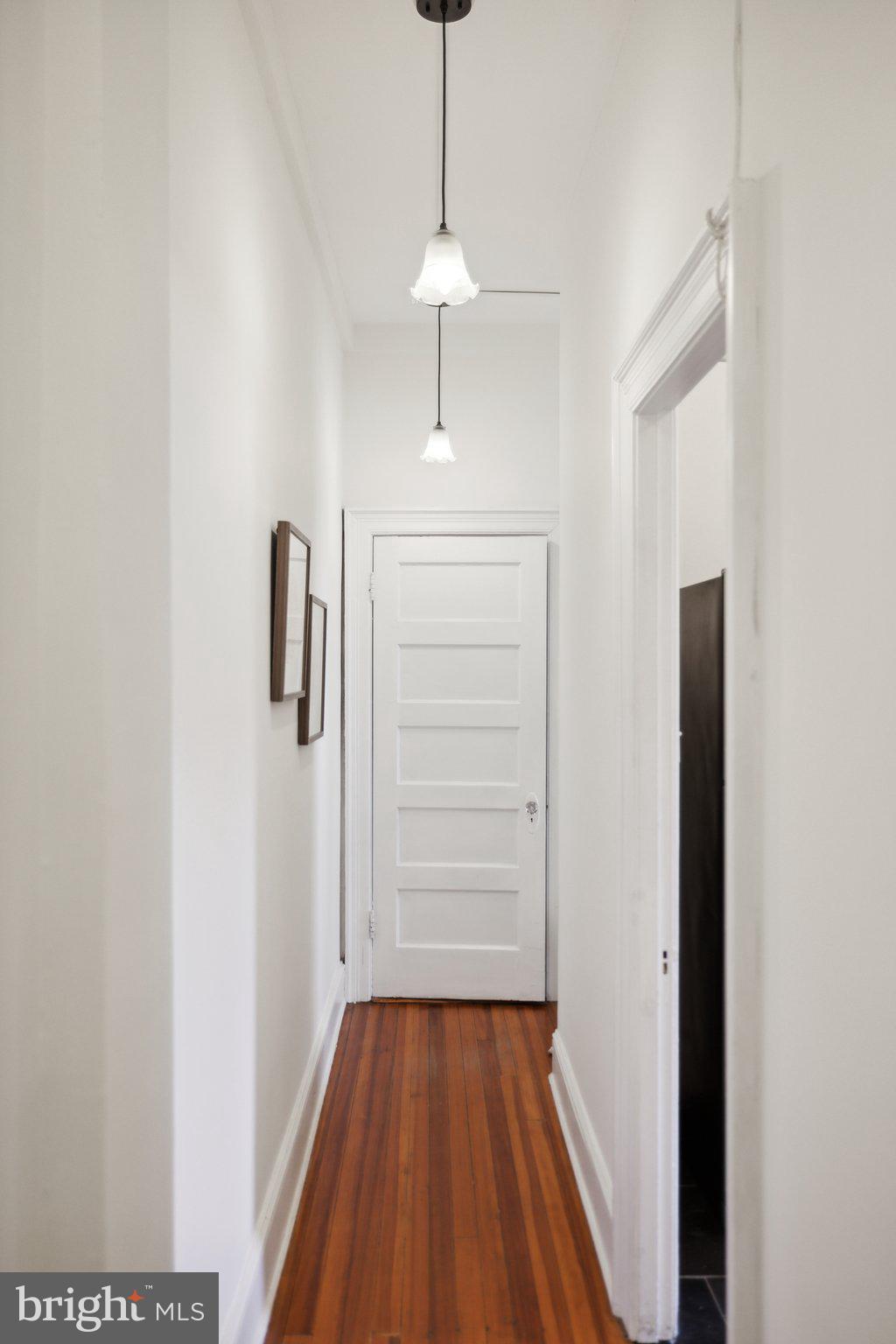 1852 Columbia Road Northwest, Unit 503 Washington, DC 20009 - Photo 21 of 32 a view of a hallway with wooden floor