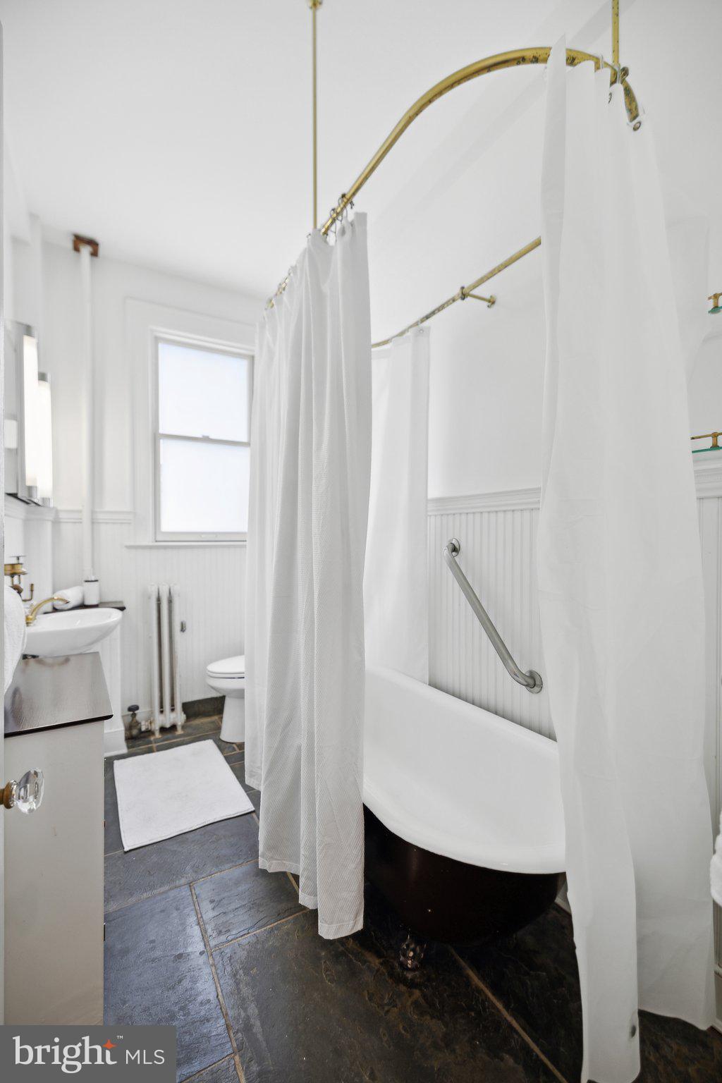 1852 Columbia Road Northwest, Unit 503 Washington, DC 20009 - Photo 27 of 32 a bathroom with a sink a toilet and shower