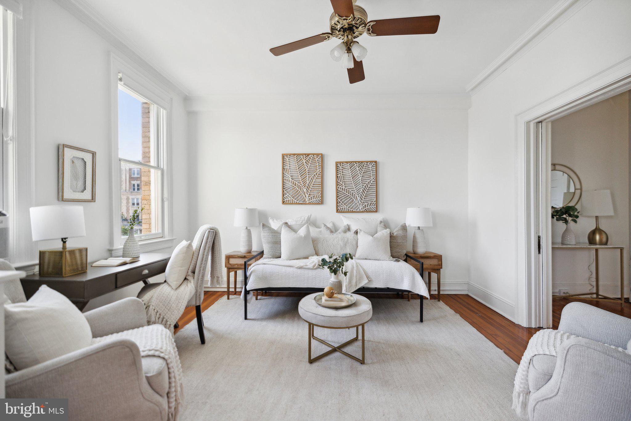 1852 Columbia Road Northwest, Unit 503 Washington, DC 20009 - Photo 7 of 32 a living room with furniture and a large window