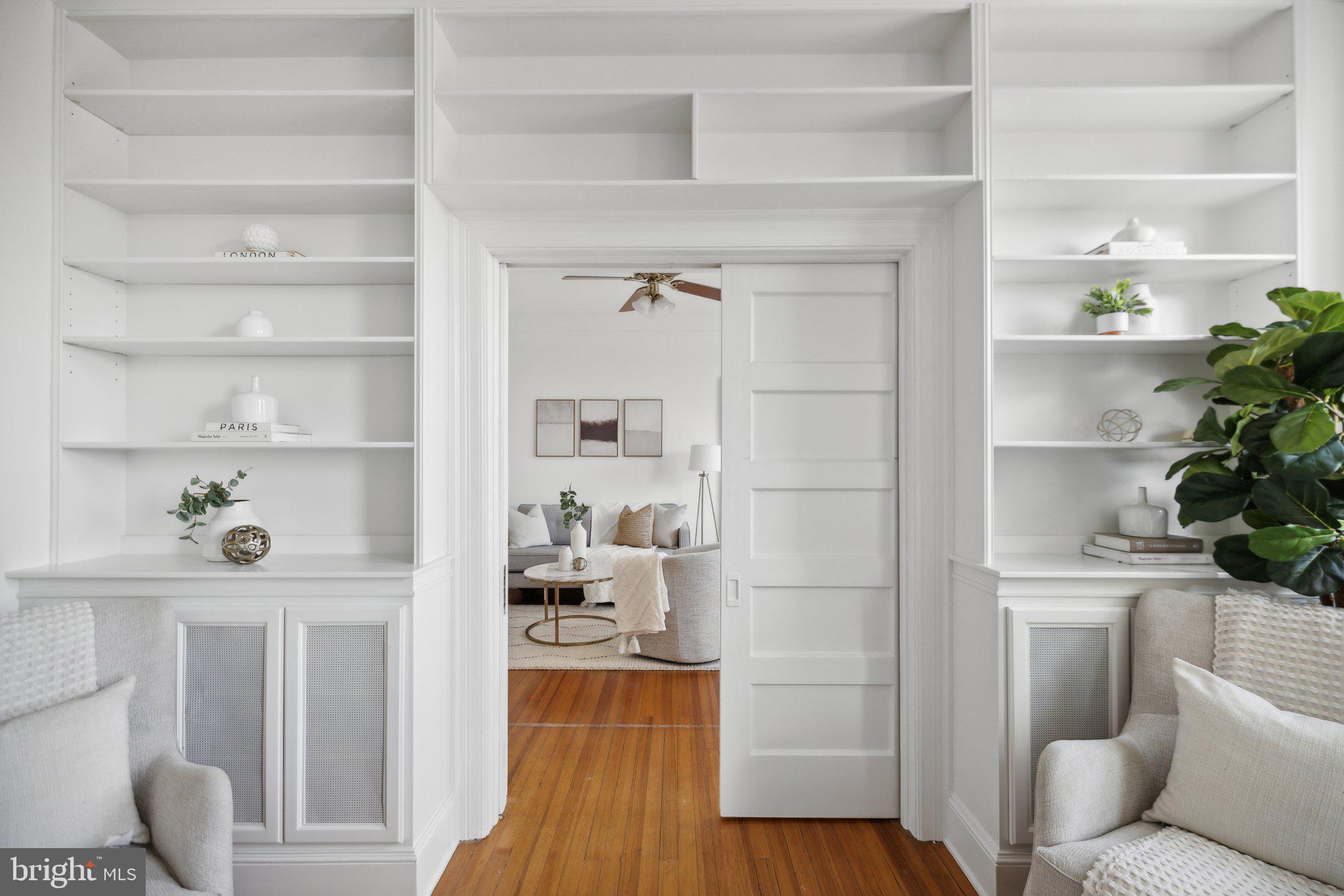 1852 Columbia Road Northwest, Unit 503 Washington, DC 20009 - Photo 8 of 32 a living room with a couch and a potted plant on the wall