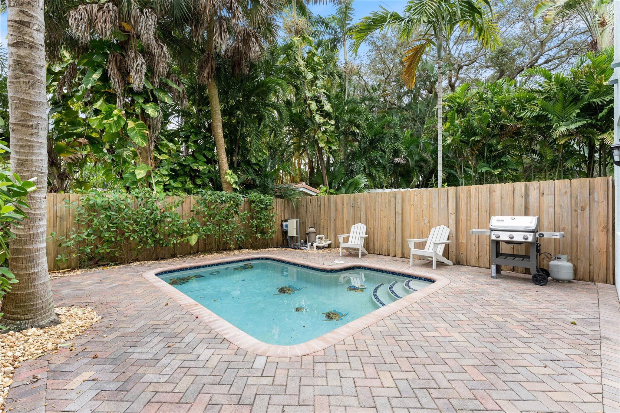 950 Southwest 7th Street, Unit 950 Fort Lauderdale, FL 33315 - Photo 35 of 42 a backyard of a house with barbeque oven and wooden fence