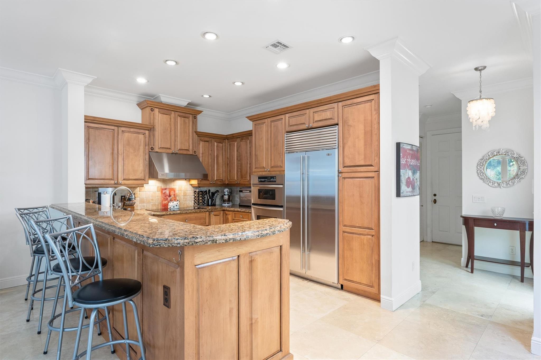 950 Southwest 7th Street, Unit 950 Fort Lauderdale, FL 33315 - Photo 5 of 42 a kitchen with stainless steel appliances granite countertop a table chairs and a refrigerator