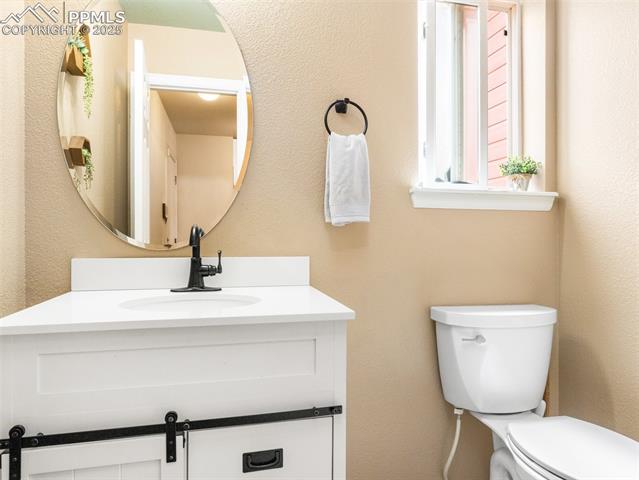 5346 Gentle Wind Road Colorado Springs, CO 80922 - Photo 13 of 28 Bathroom featuring vanity and toilet