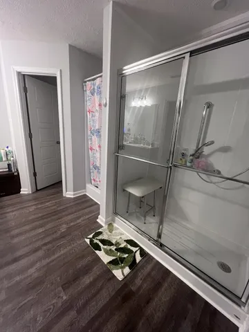 a room with a glass door shower and a fireplace
