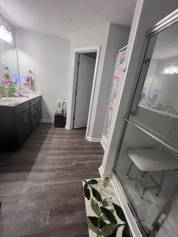 a hallway with a view of living room with furniture and a rug