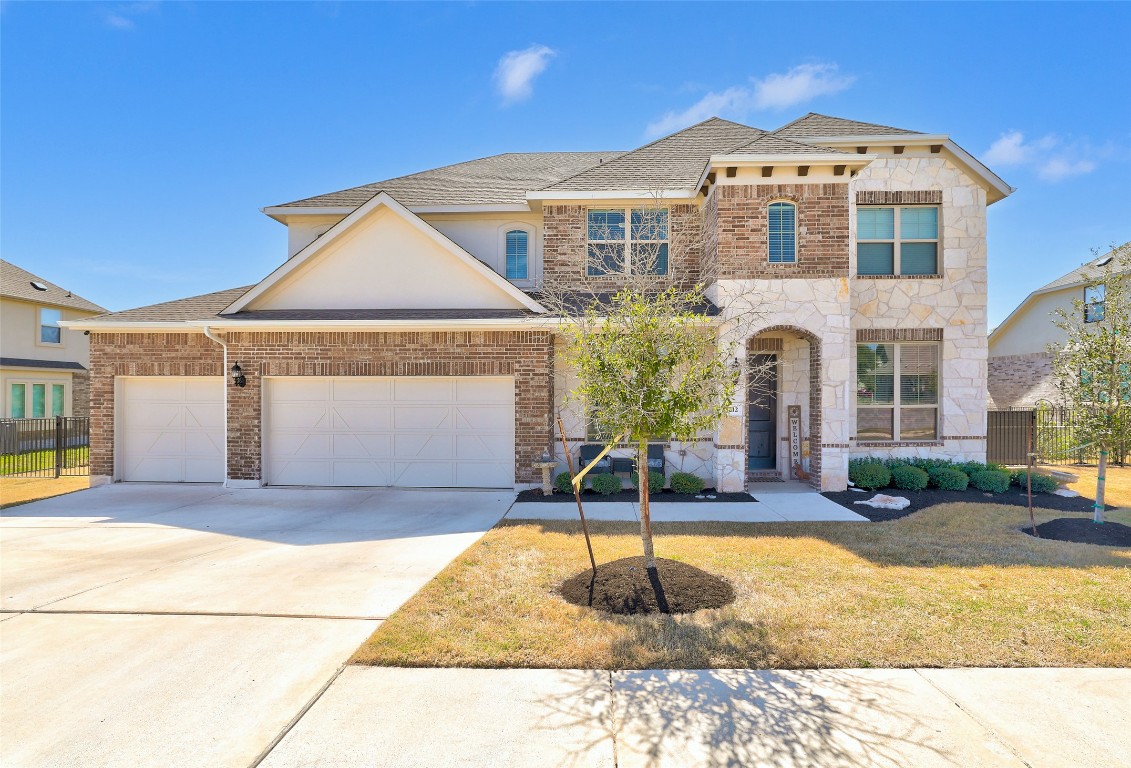 a front view of a house with a yard