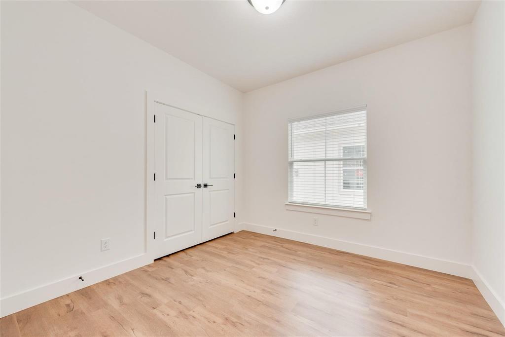 1807 Franklin Street Bonham, TX 75418 - Photo 7 of 13 an empty room with wooden floor and windows