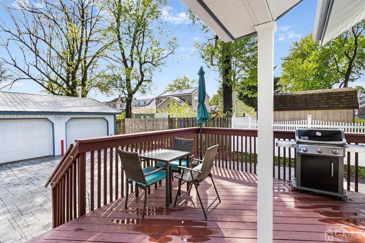 235 New Market Road Dunellen, NJ 08812 - Photo 24 of 25 a view of a roof deck with table and chairs with wooden floor and fence