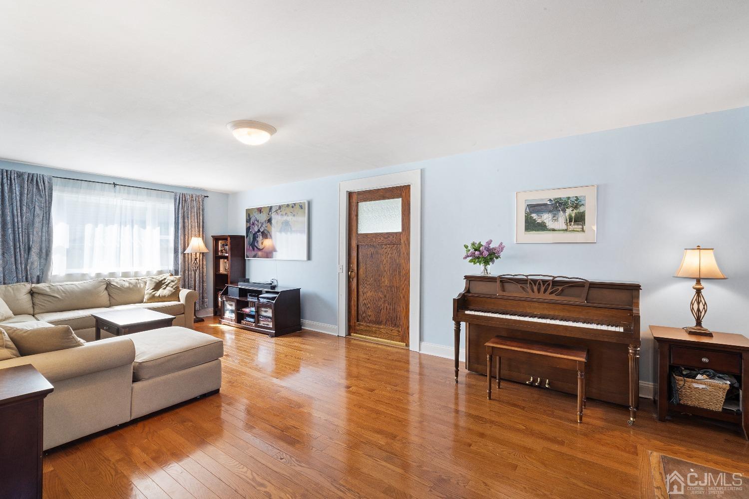 235 New Market Road Dunellen, NJ 08812 - Photo 3 of 25 a living room with furniture and wooden floor