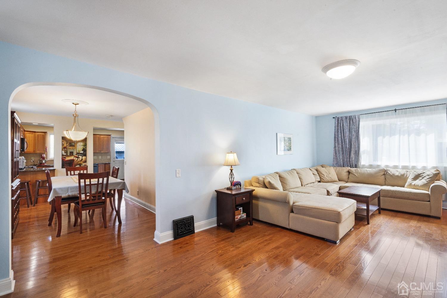 235 New Market Road Dunellen, NJ 08812 - Photo 4 of 25 a living room with furniture and a wooden floor