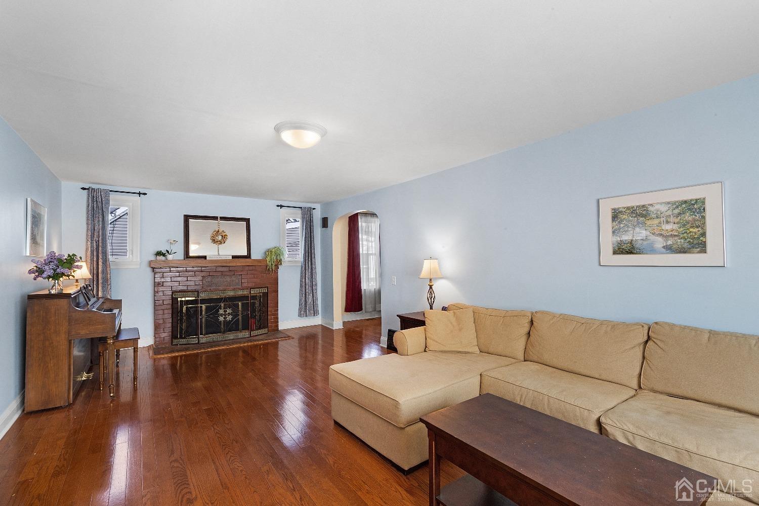 235 New Market Road Dunellen, NJ 08812 - Photo 5 of 25 a living room with furniture flat screen tv and a fireplace