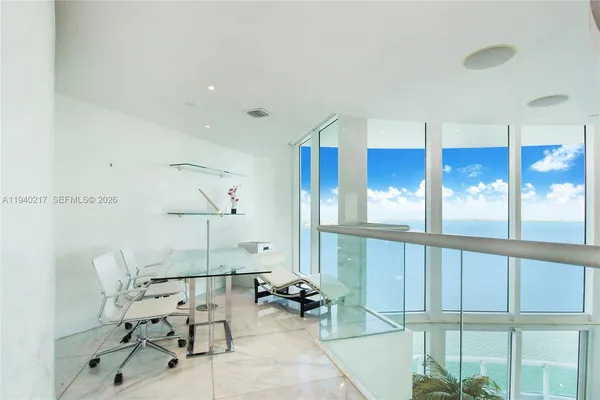 a living room with furniture and a floor to ceiling window