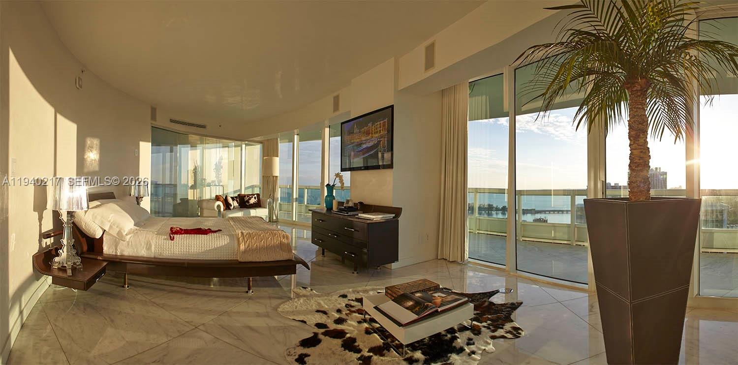 1643 Brickell Avenue, Unit 2902 Miami, FL 33129 - Photo 16 of 32 a living room with furniture and a floor to ceiling window