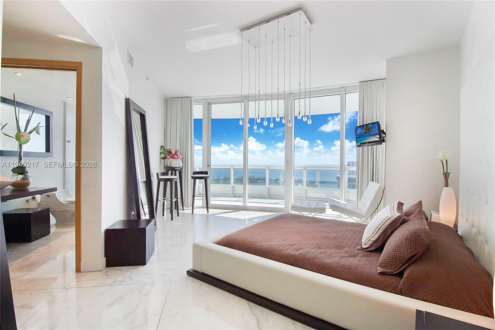 1643 Brickell Avenue, Unit 2902 Miami, FL 33129 - Photo 21 of 32 a living room with furniture and a large window
