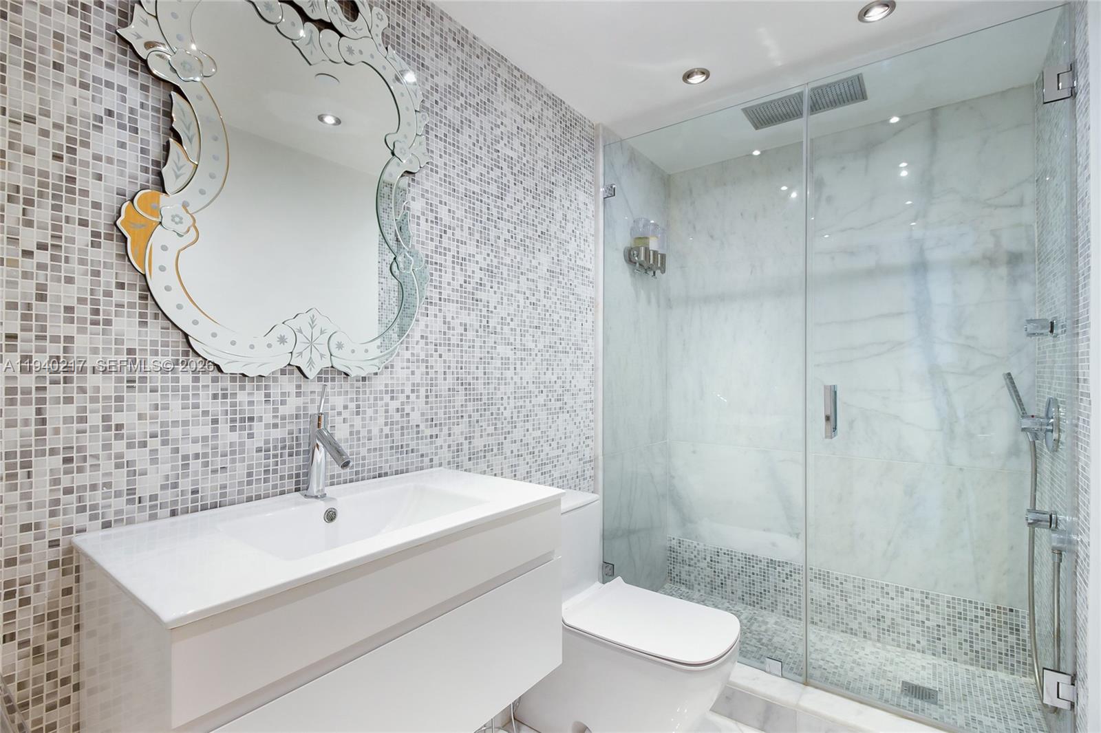 1643 Brickell Avenue, Unit 2902 Miami, FL 33129 - Photo 29 of 32 a bathroom with a sink a toilet and shower