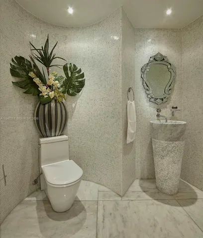 a bathroom with a toilet sink and shower